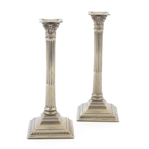 A pair of George III Paktong brass candlesticks with visible tarnish
