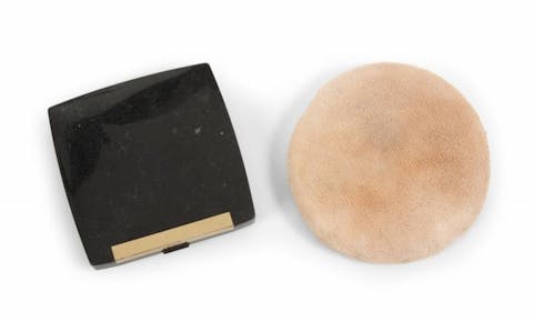A powder compact and applicator owned by Michael Jackson used throughout the 1990s