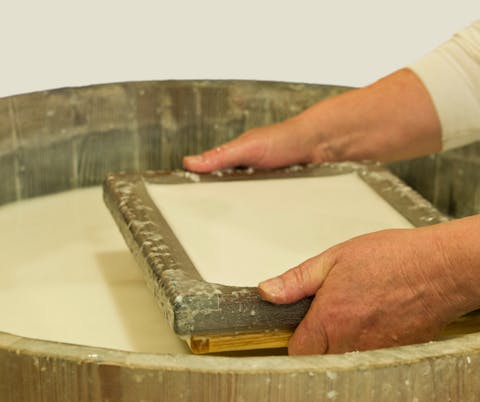 process of making paper, a person making paper