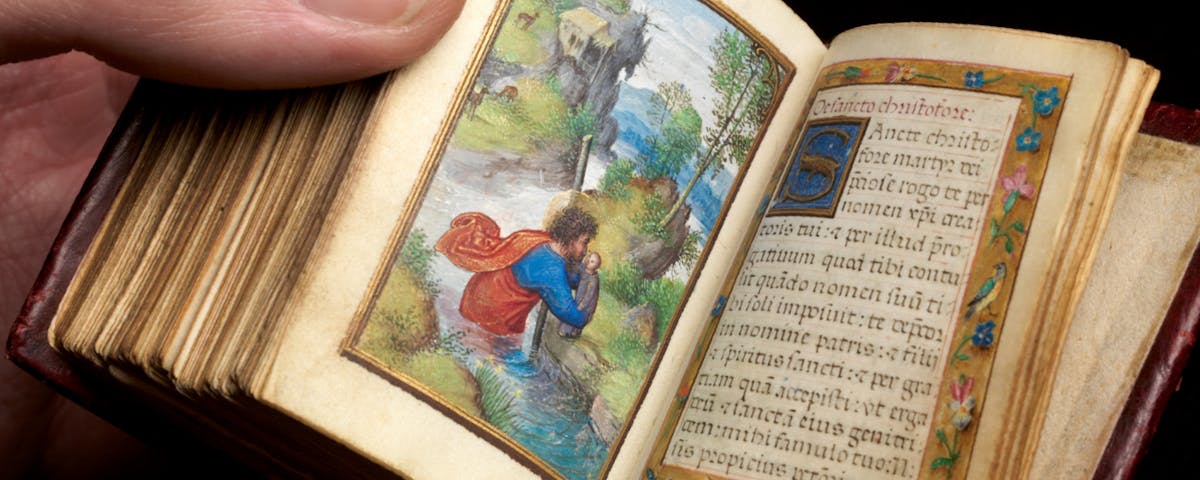 person holding miniature book