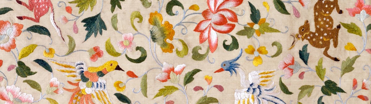 Vintage tapestry with floral and animal motifs.