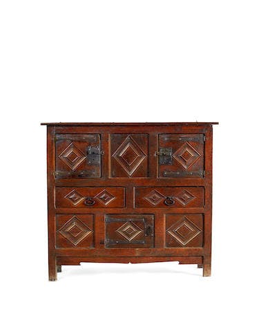 An exceptional and rare Henry VIII joined oak livery cupboard, circa  1520 - 40