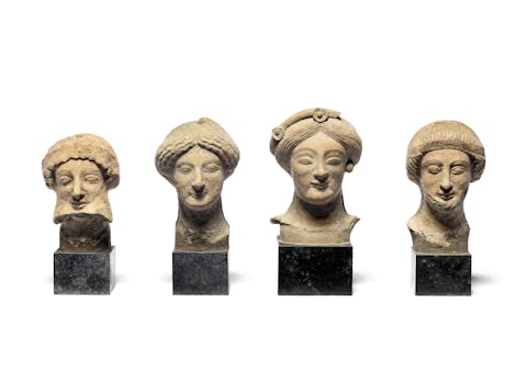 Four Greek terracotta heads, circa 5th Century B.C., 9.5 – 11.5cm high