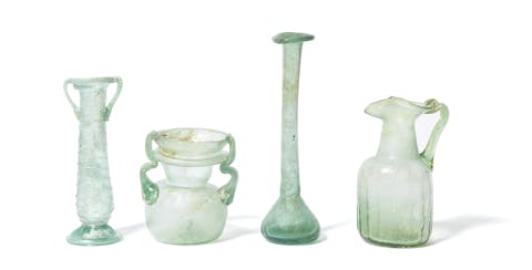 Four Roman green glass vessels, circa 2nd-6th Century A.D., 7.5-14.5cm high