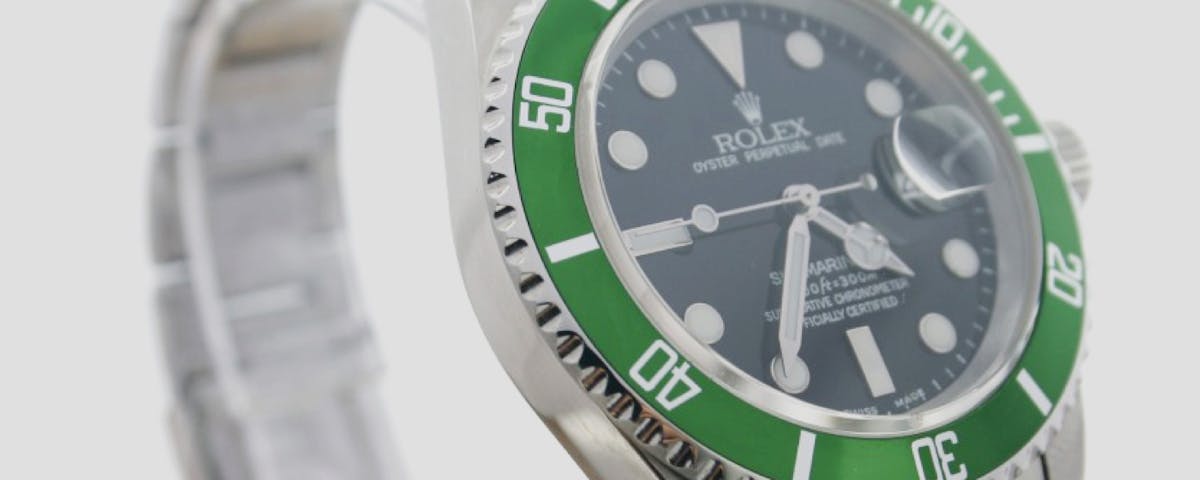 Rolex Submariner with black dial and green bezel.