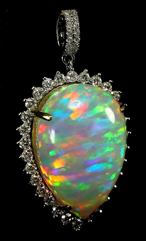 20.05 carat Ethiopian Welo (Wello) opal set in 14k gold and surrounded by diamonds.