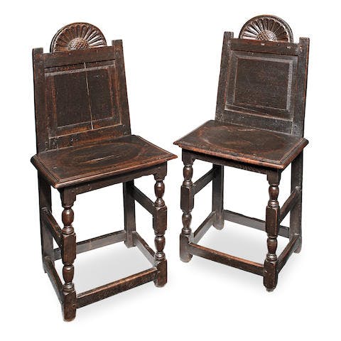 An extremely rare and documented pair of James I joined oak back stools, circa  1620