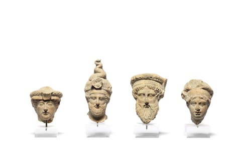 Four Greek terracotta male heads, Taranto, circa 4th Century B.C., 6cm – 11cm high