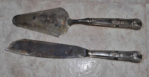 Silver cake knife and server, unpolished. The black coating is silver sulfide