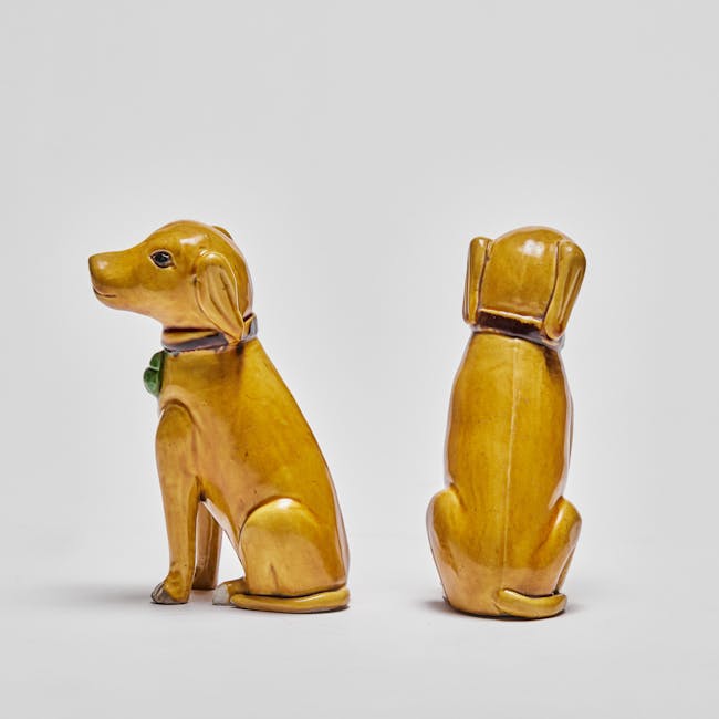 Chinese enamel on biscuit porcelain seated dogs