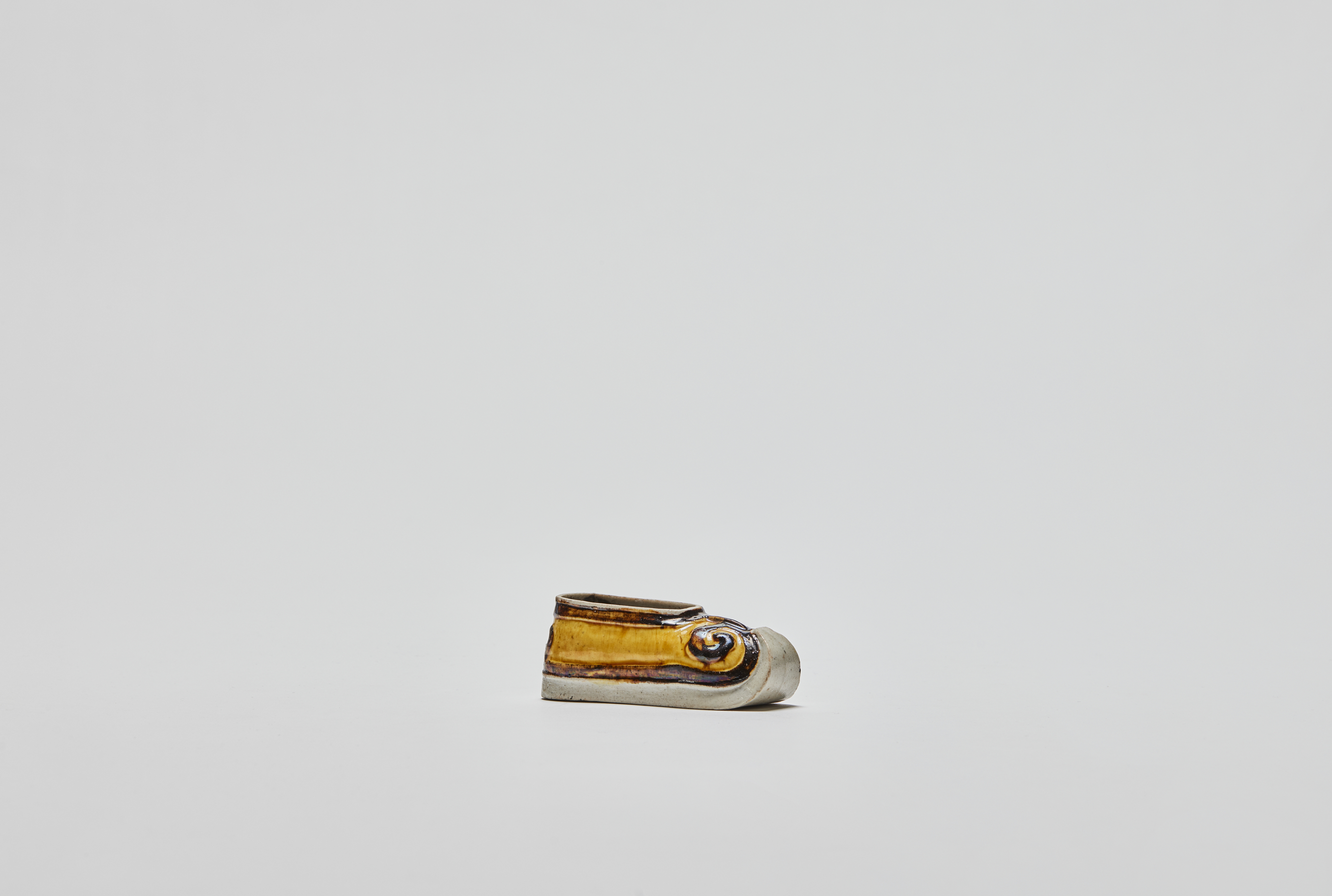 chinese enamel on biscuit model of yellow shoe pointing right