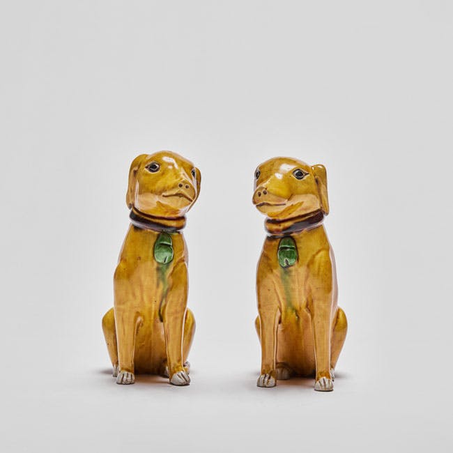 Chinese enamel on biscuit porcelain seated dogs