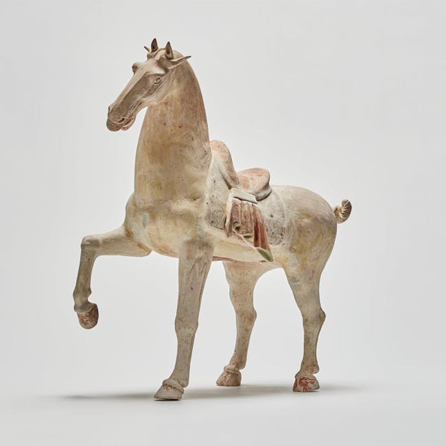 Chinese pottery prancing horse from the Tang dynasty left facing side