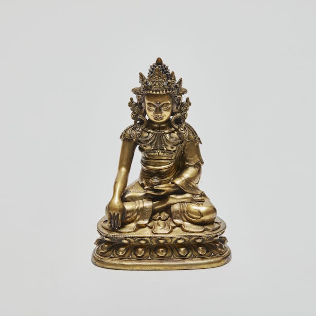 Sino-Tibetan gilt-bronze figure of Buddha Akshobhya in lotus position 