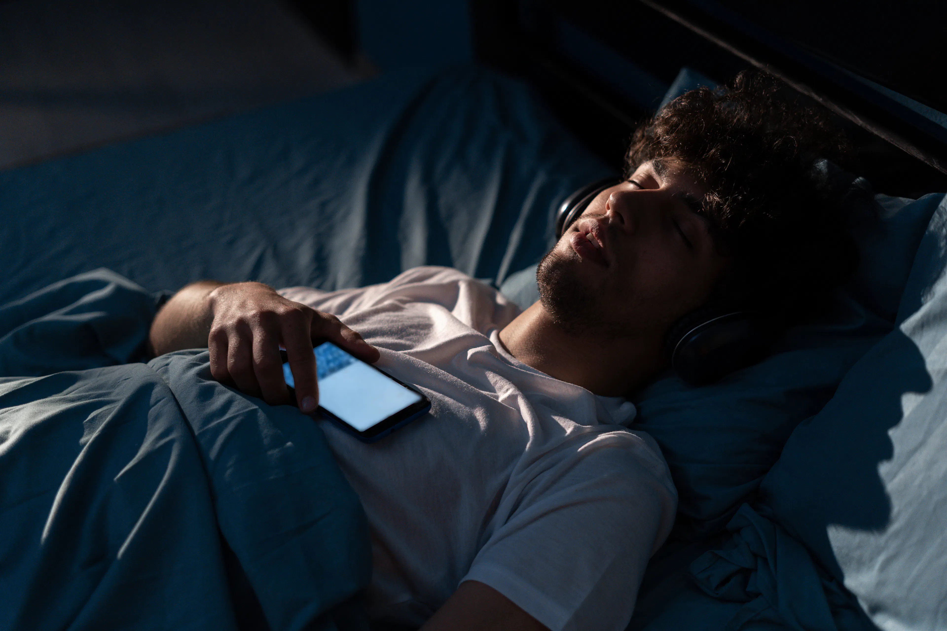 man sleeping with phone in hand