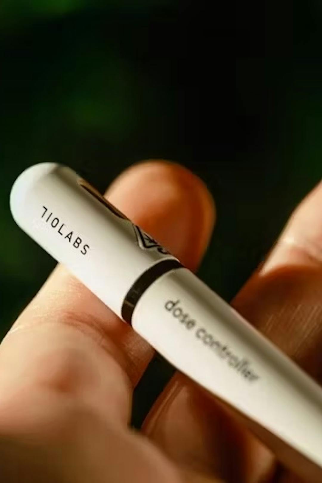 A hand holding a 710 labs dose controller