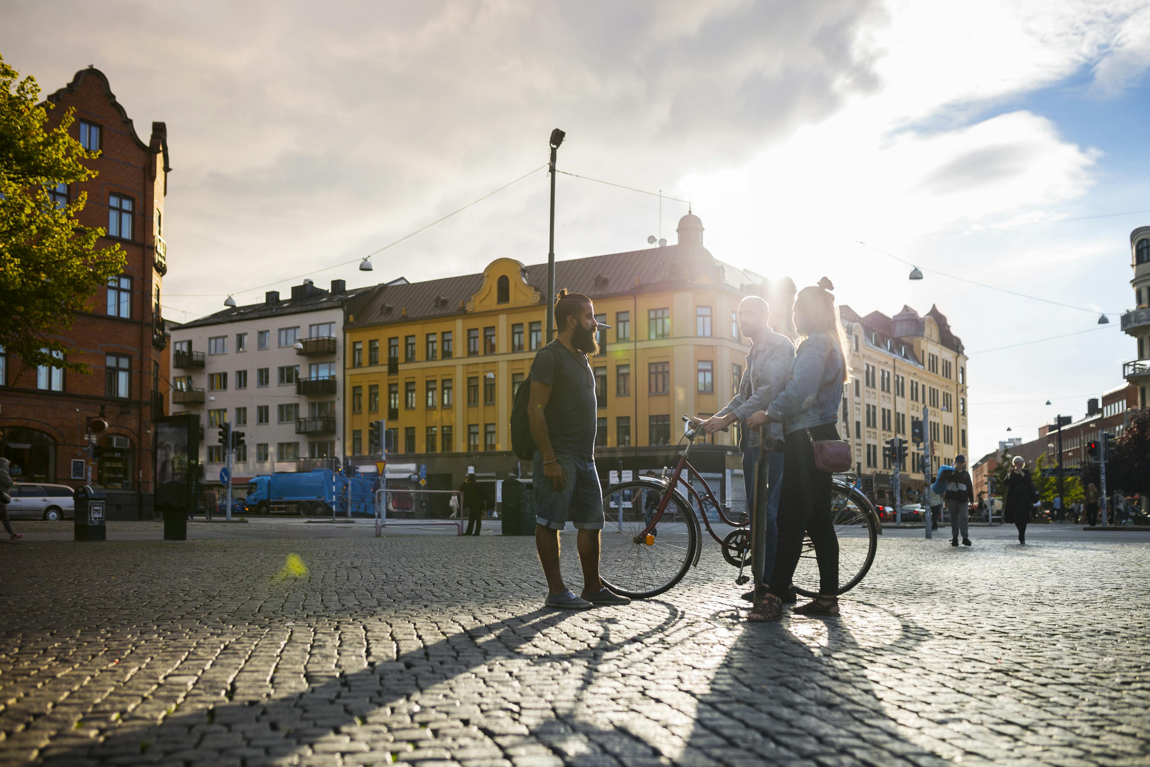 Three friends standing in town square
