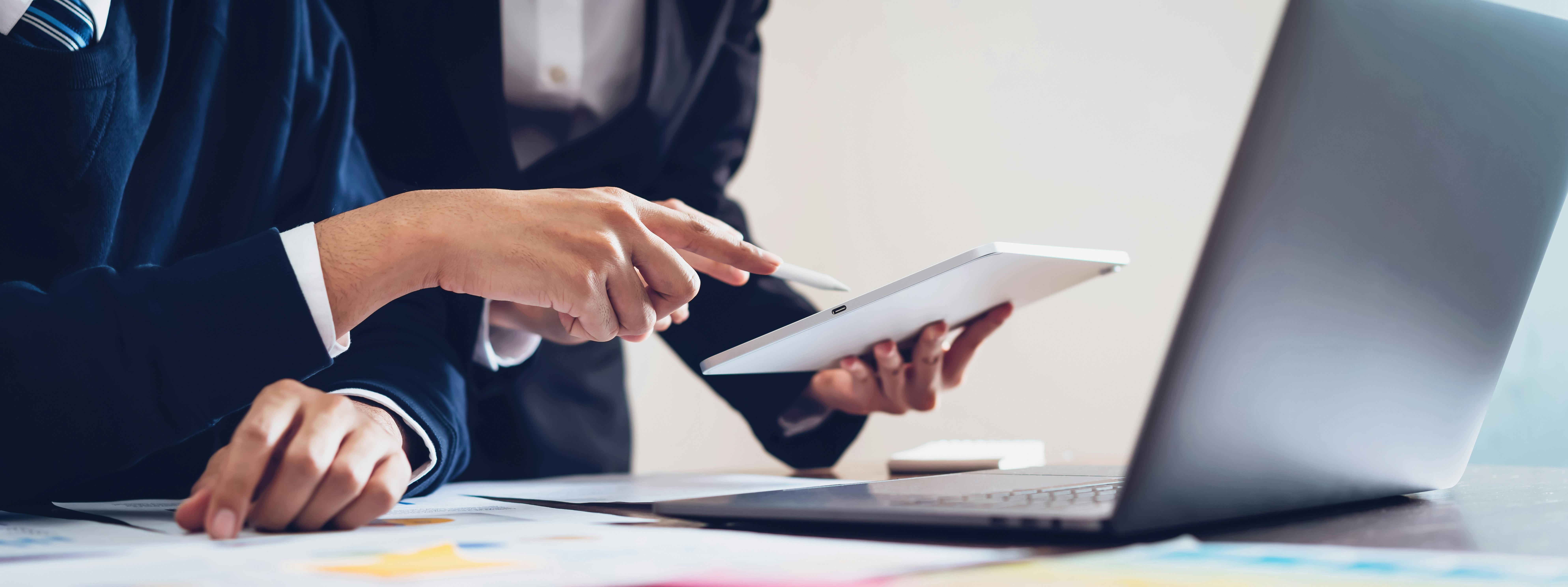 two people looking at an electronic document