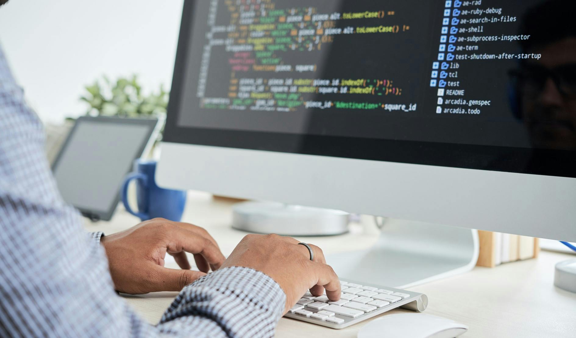 person typing code on a computer