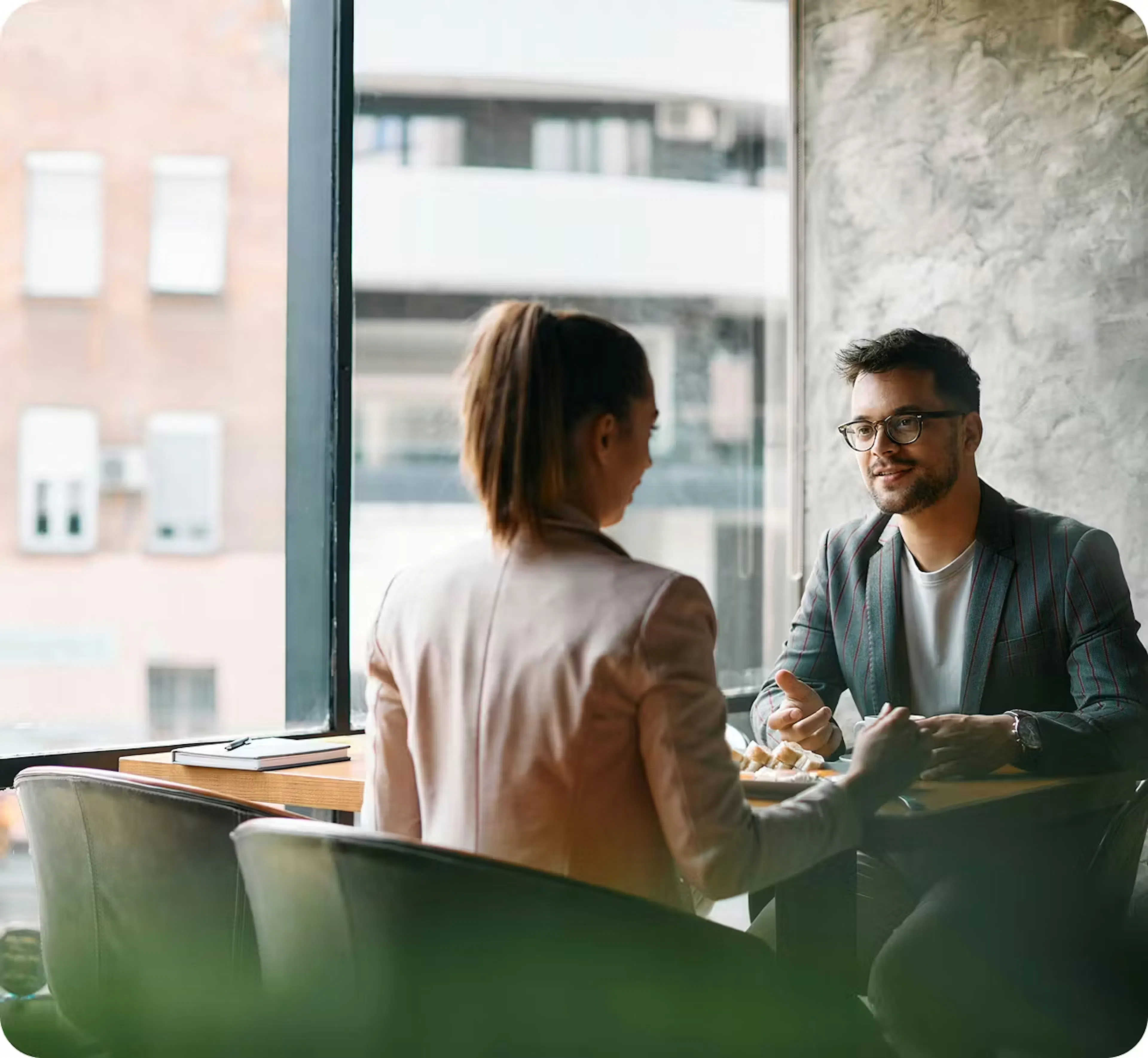 Two professionals meeting in a bright office, representing trusted, transparent financial guidance and real human support for Canadians.
