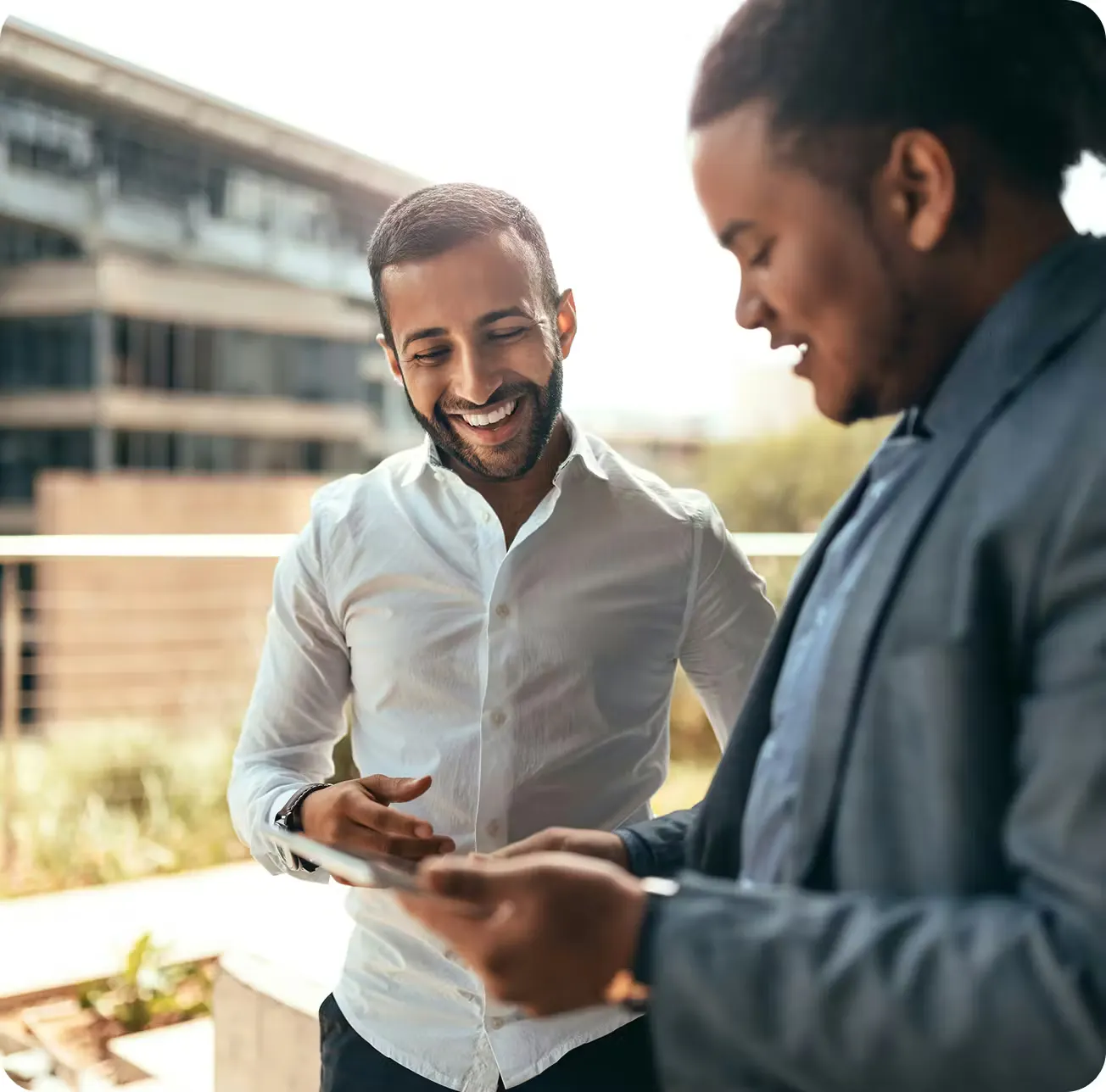 Customers reviewing a mobile device while selling crypto for CAD with VBX