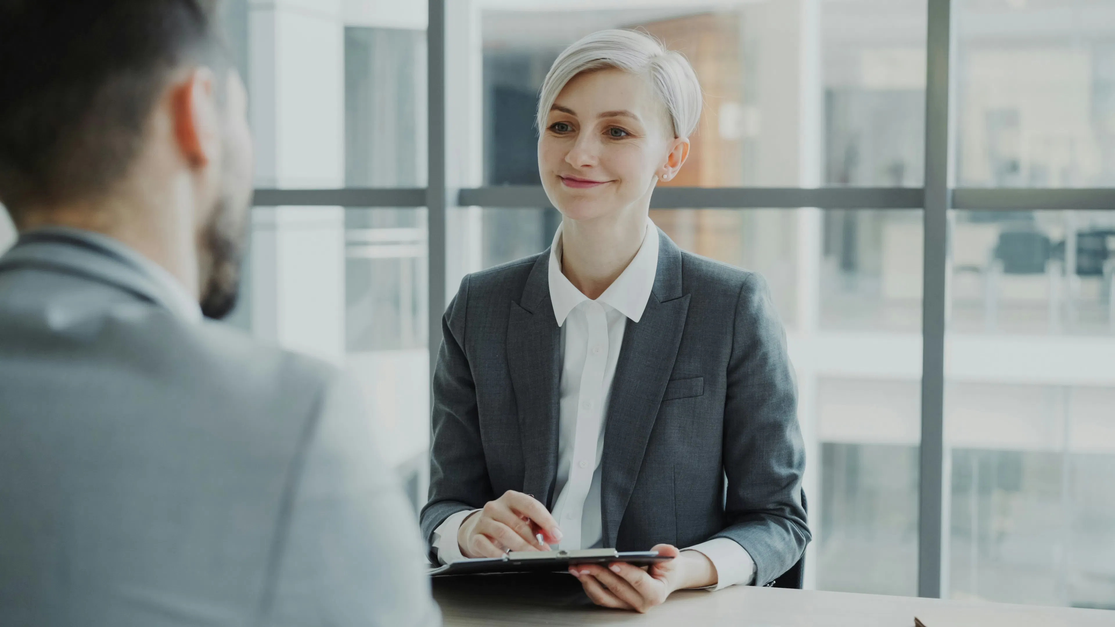 Two professionals reviewing documents in an office setting, representing crypto compliance in Canada