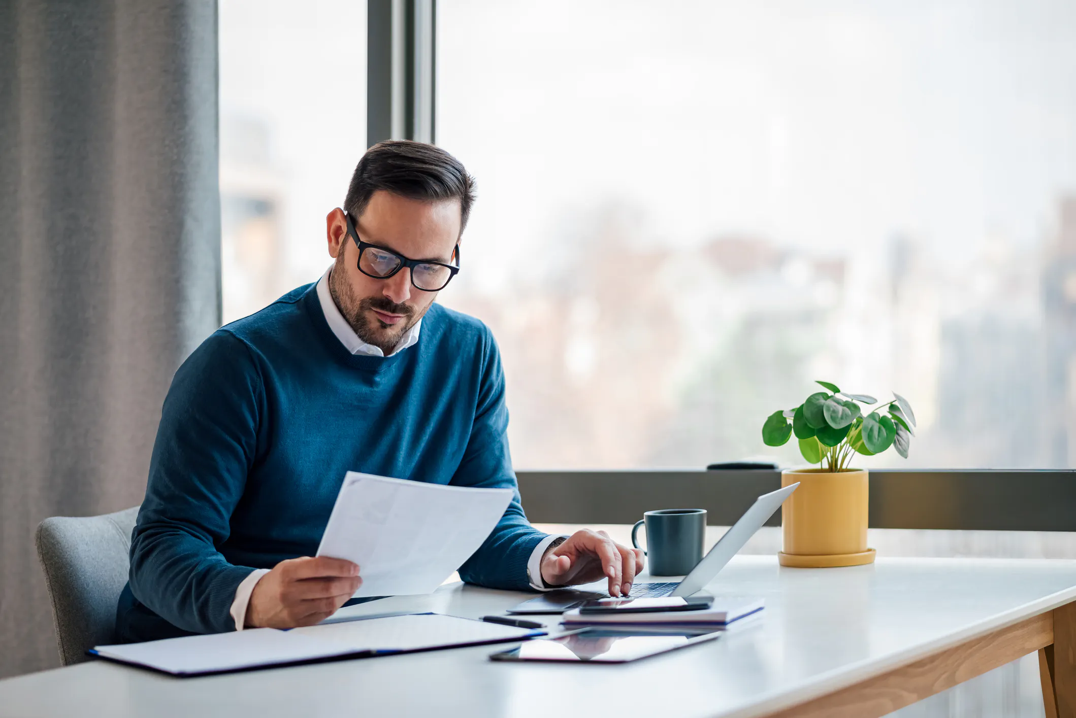 Canadian investor reviewing documents related to crypto taxes and compliance