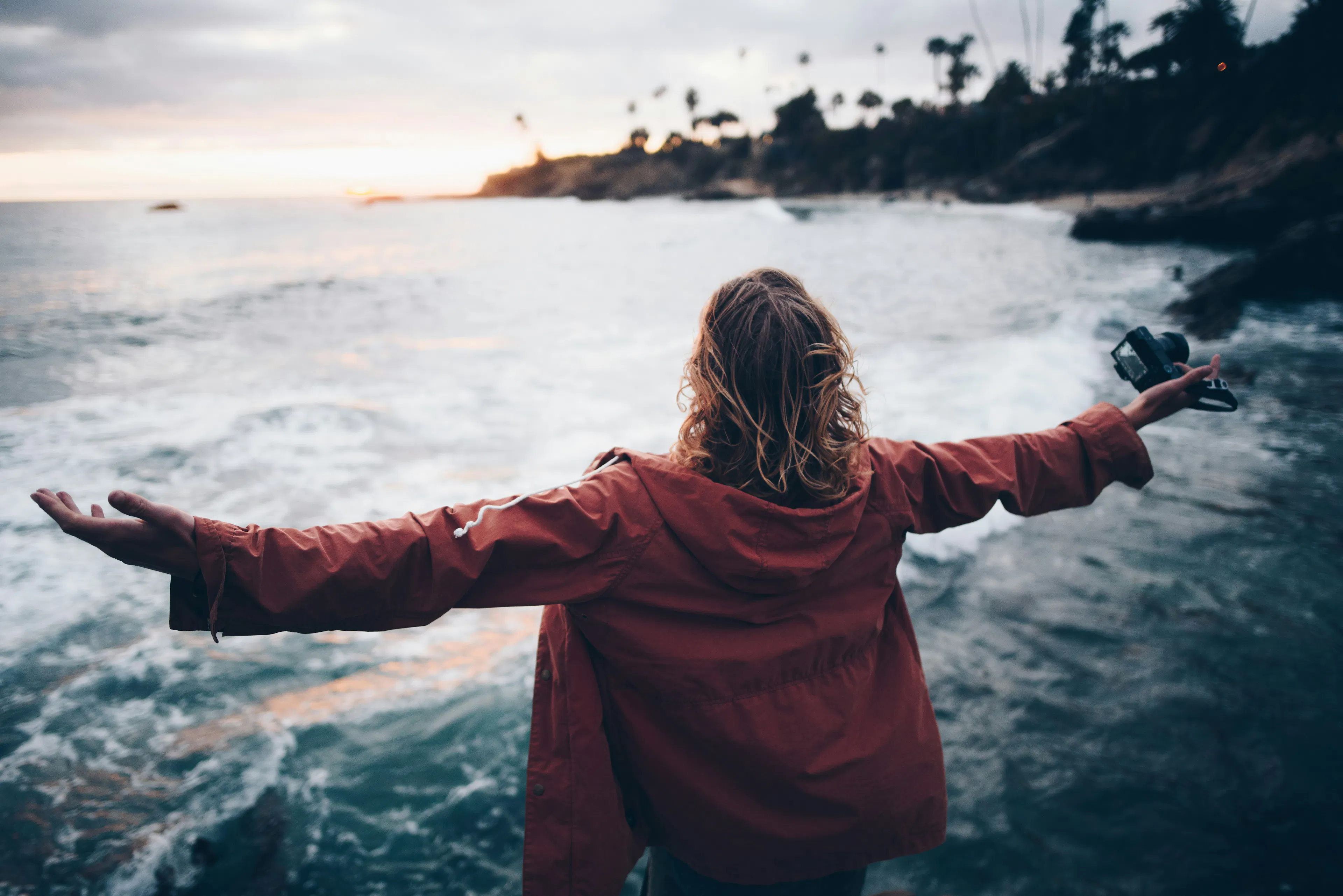 Man standing by the ocean at sunset, symbolizing freedom and self-custody with VBX.