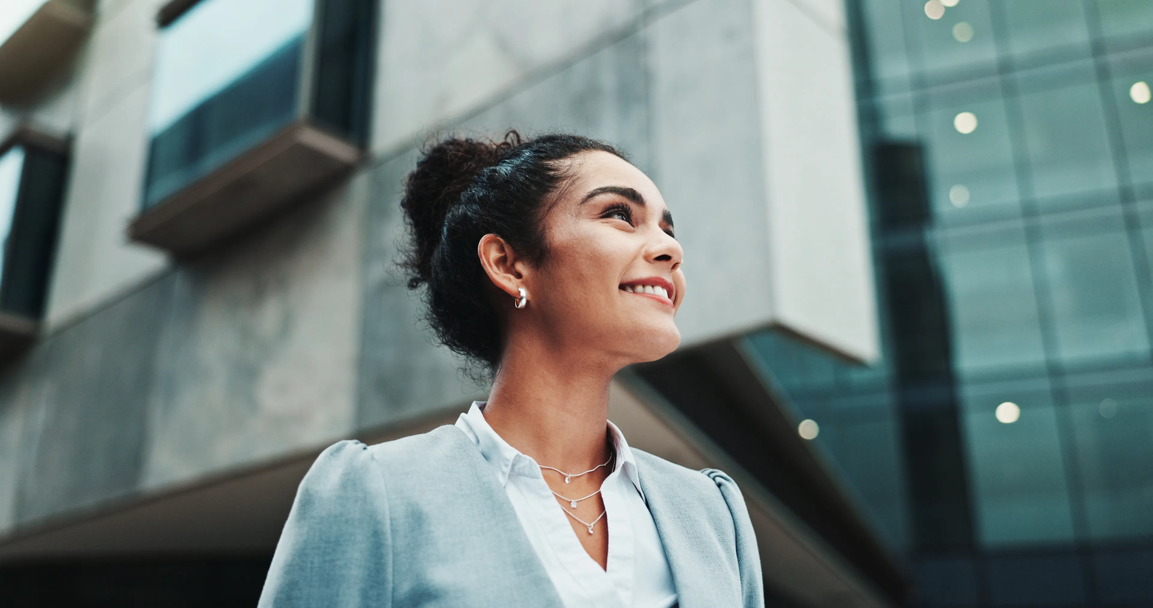 Confident professional woman smiling in the city, representing a VBX client who keeps her crypto in her own wallet
