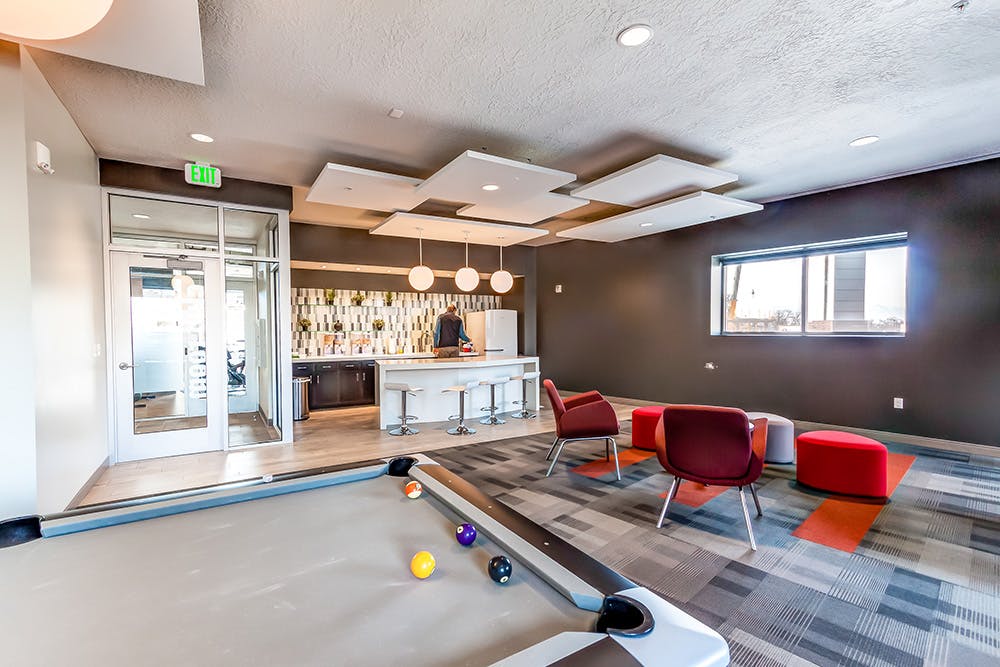 Wilmington Gardens community area with a kitchen, pool table, and seating