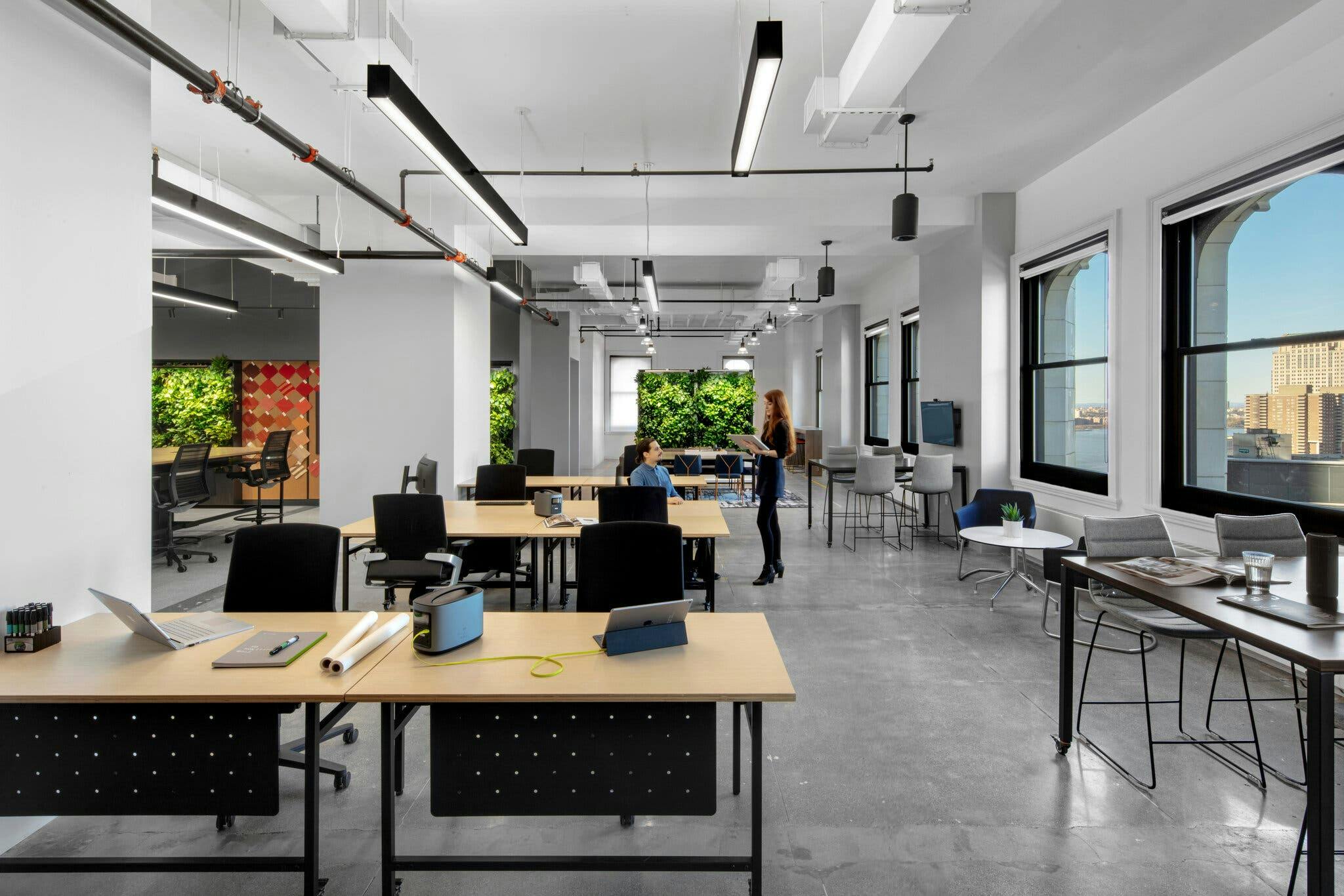 modern office with employees collaborating and lots of natural light, and agile workspaces