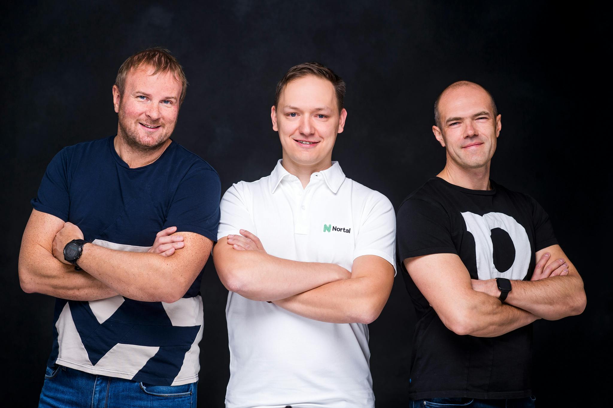 Three men standing together with their arms folded.