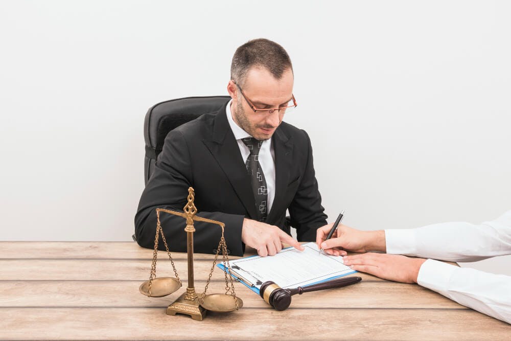 Lawyer Instructing Client Where to Sign