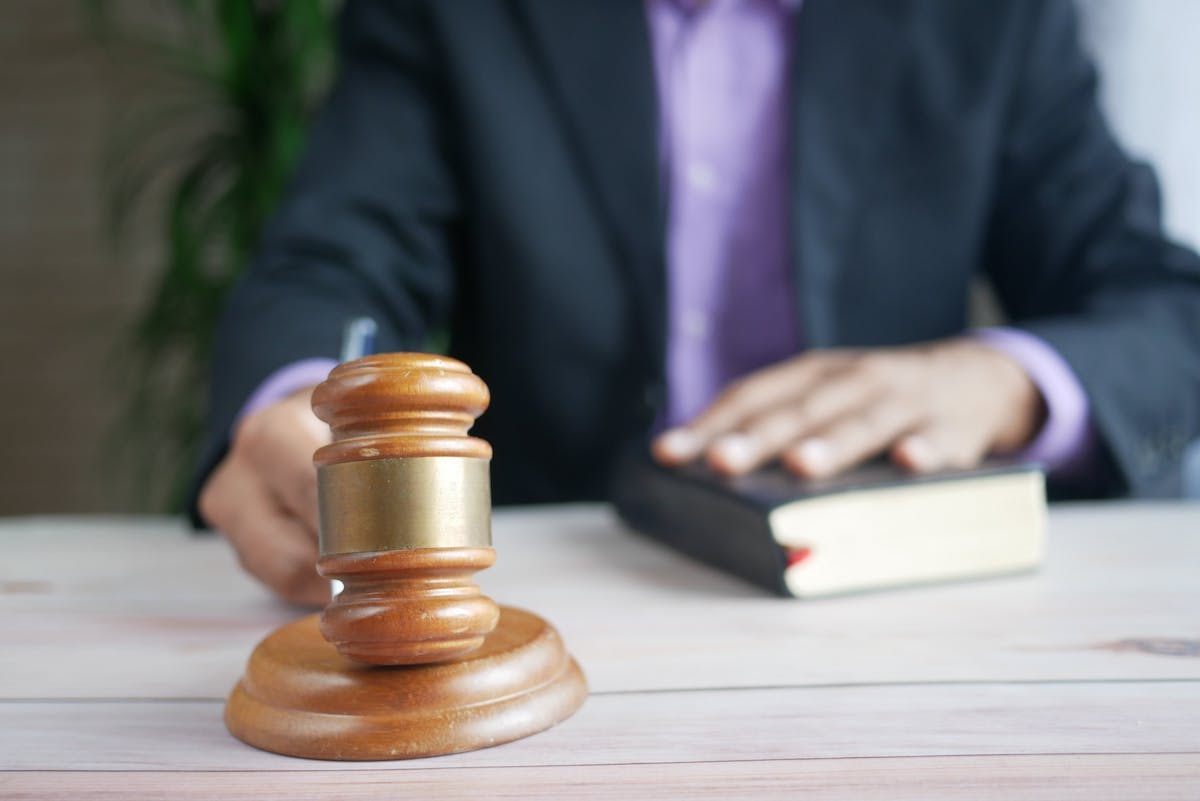 Lawyer With Gavel and His Hand on a Book