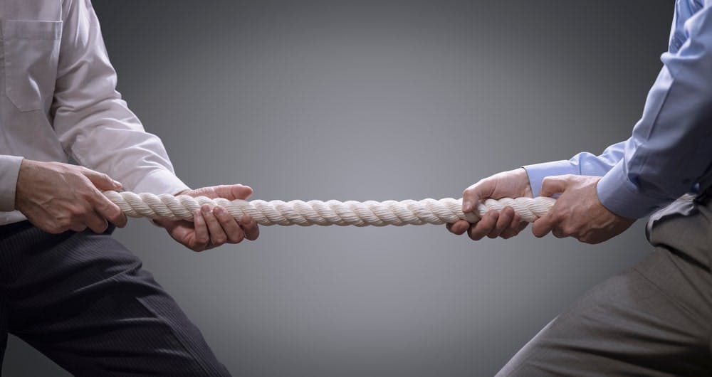 Two Persons Holding Rope And Stretching It From Both Sides