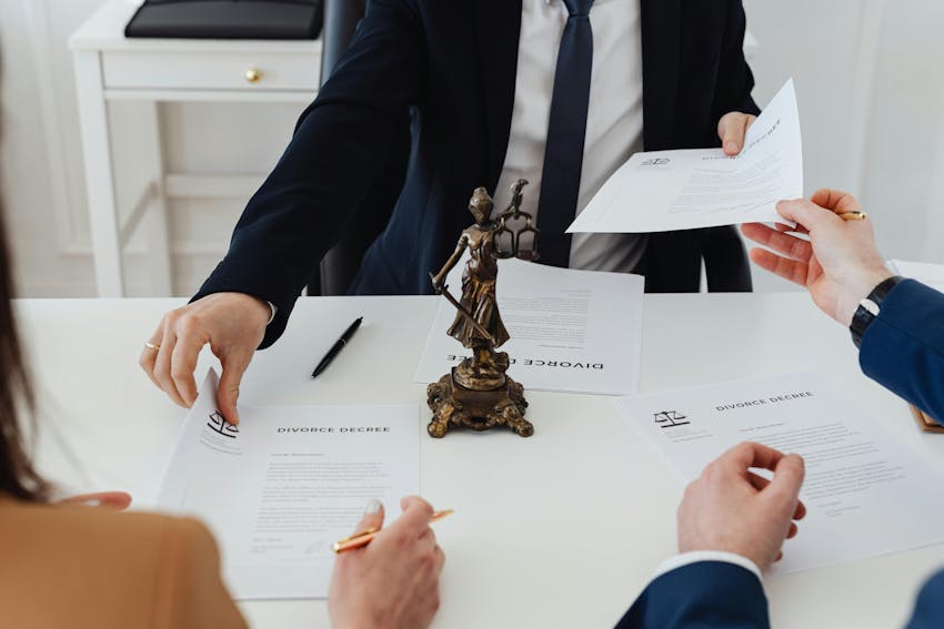A legal team reviews important documents at a desk, symbolizing professional legal support for defamation and reputation protection cases.