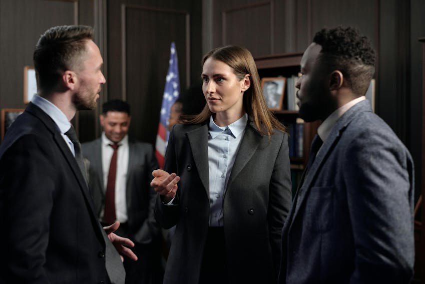 Lawyers discussing online defamation and false review cases in a law office.