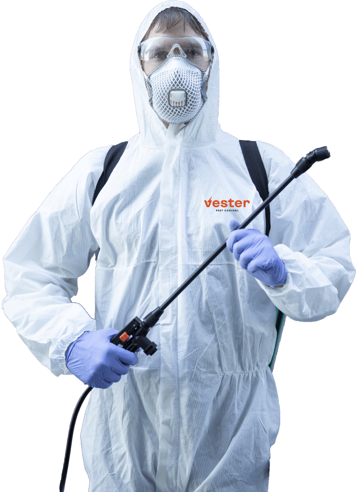 pest control specialist holding spray gun