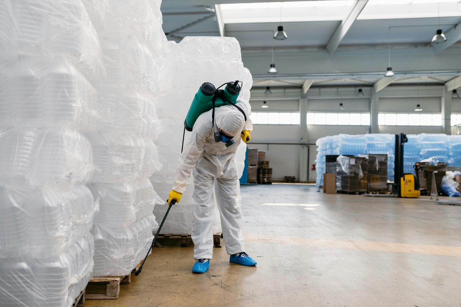 pest control specialist spraying warehouse