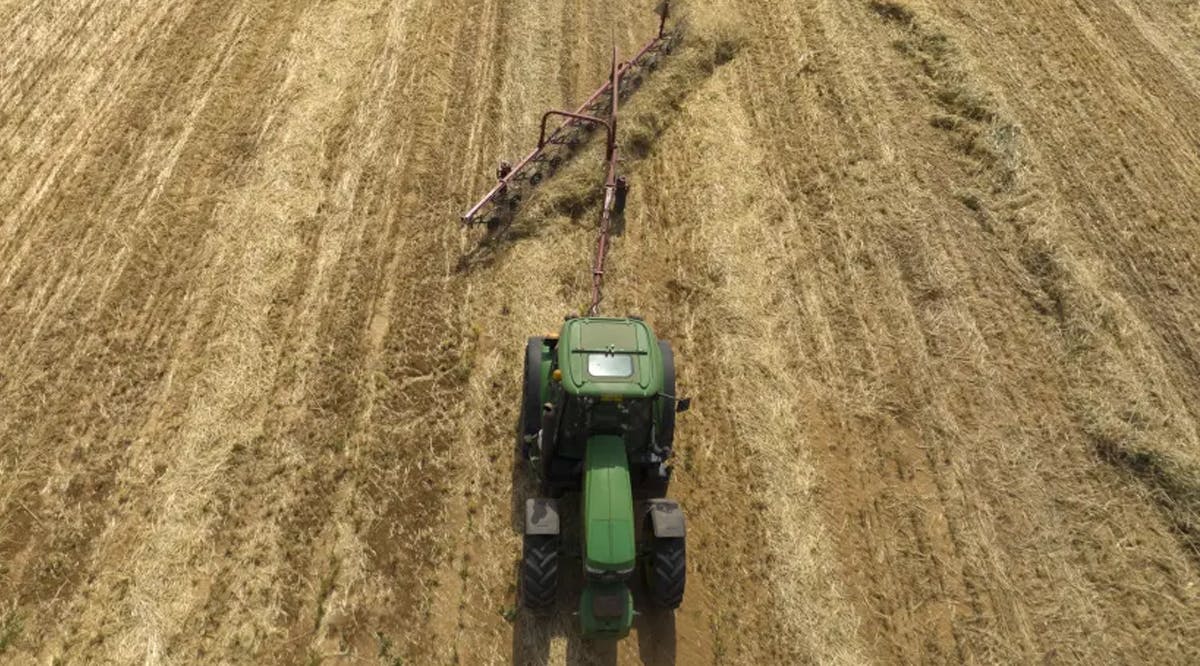 An ariel view shows a farmer harvests wheat with a machine in central Israel