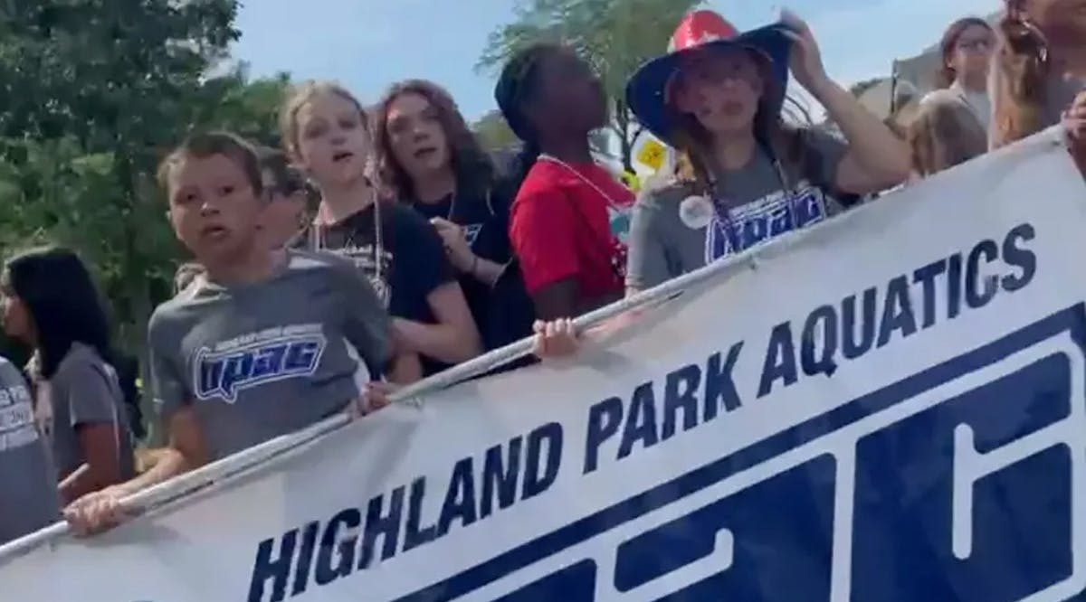Children, carrying a Highland Park Aquatics banner