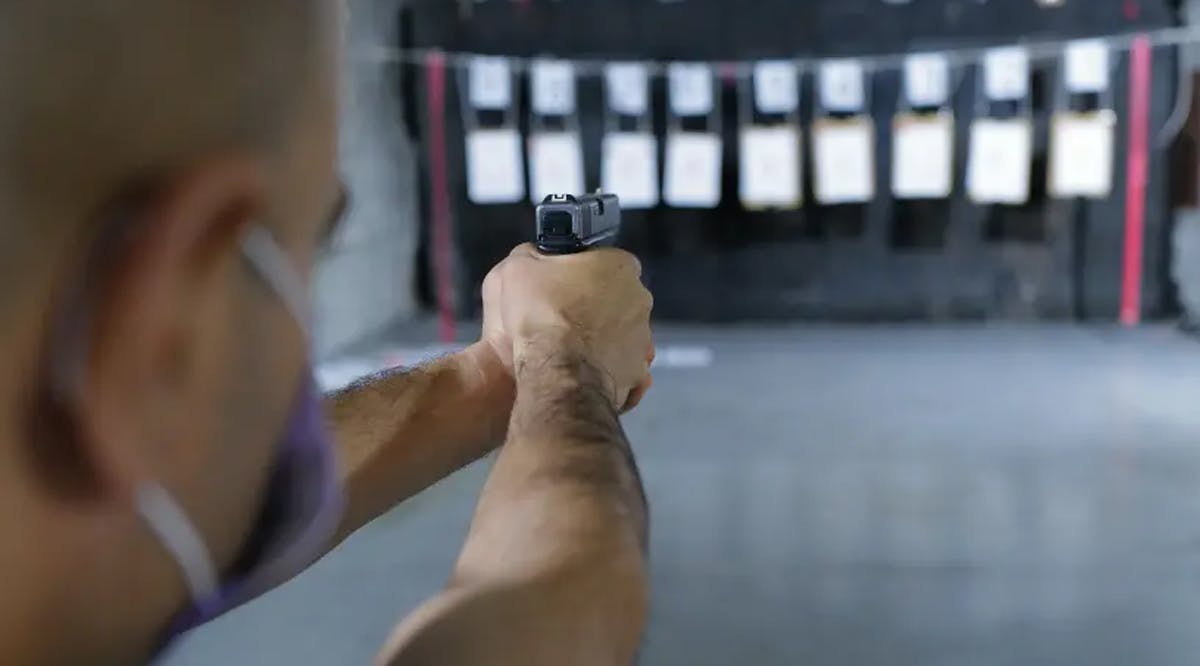 Israelis practice shooting handguns at a local shooting range in the northern town of Katsrin, Golan Heights