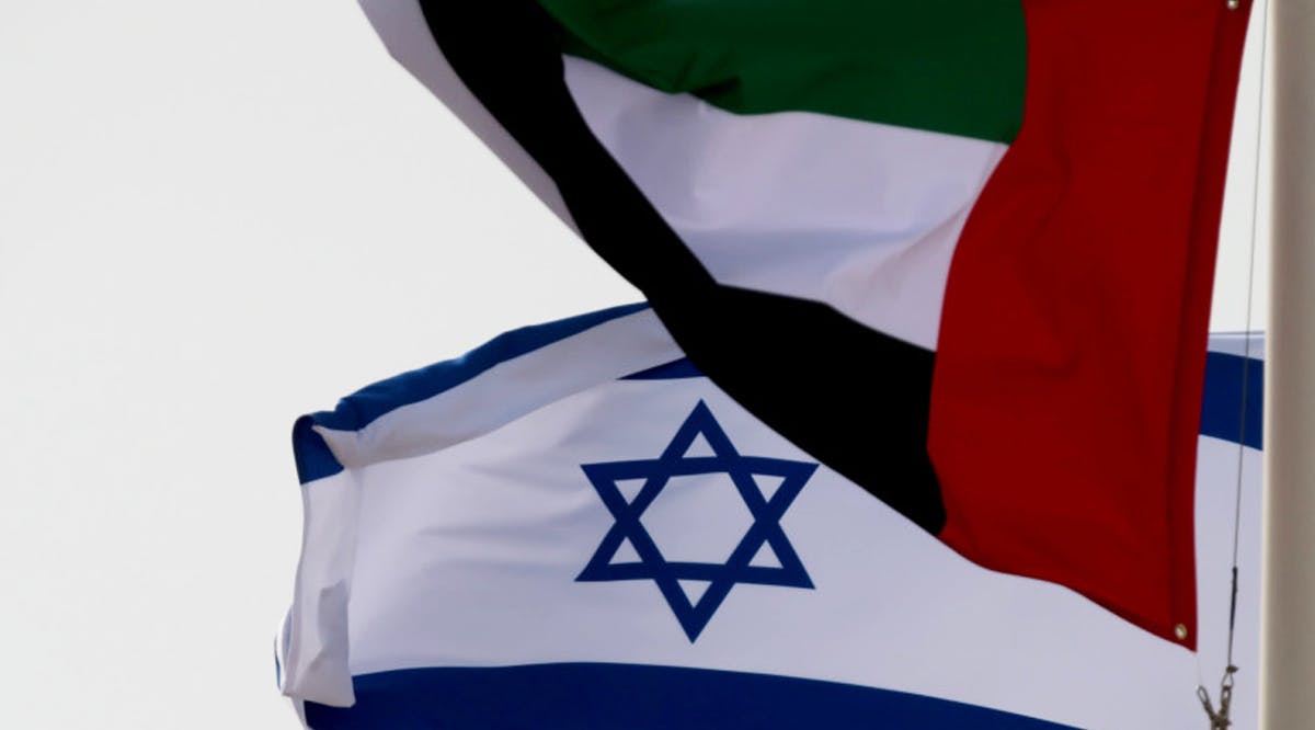 A United Arab Emirates (UAE) flag waves alongside an Israeli flag