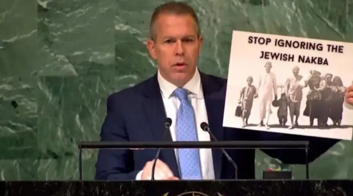 Israel's Ambassador to the UN Gilad Erdan is seen holding up a sign reading "Stop ignoring Jewish Nakba," at the United Nations