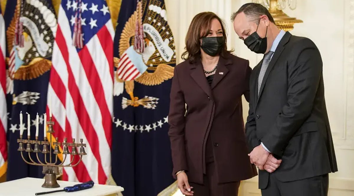 Second gentleman Doug Emhoff, the first Jewish spouse of a president or a vice president, and his wife US Vice President Kamala Harris, stand beside a menorah during a Hanukkah celebration at the White House