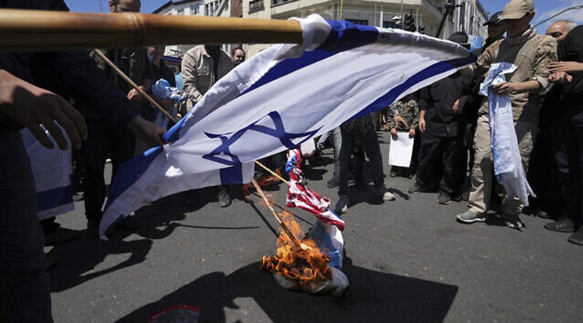 Iranian demonstrators burn representations of the Israeli and the US flags in their rally to mark Jerusalem Day, an annual show of support for the Palestinians, in Tehran, Iran