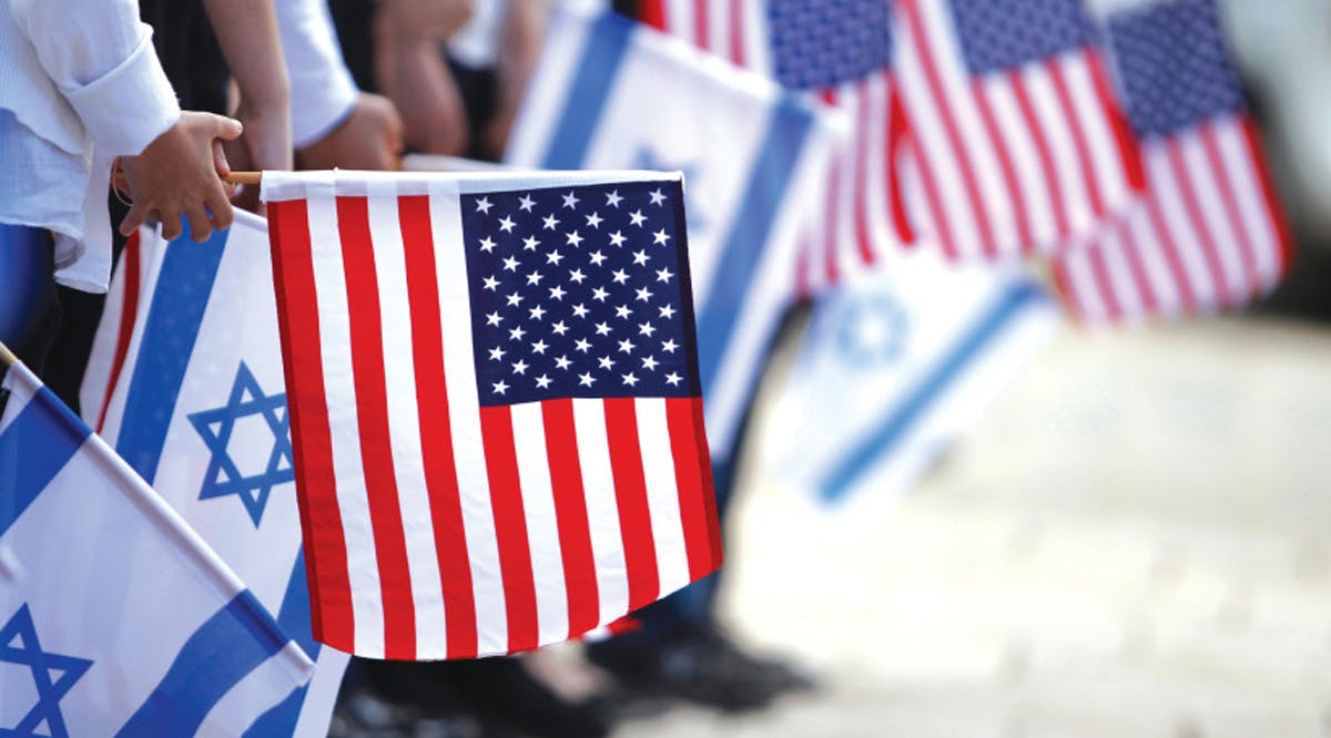 JERUSALEM SCHOOLCHILDREN hold Israeli and American flags
