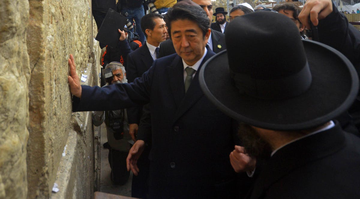 Japanese Prime Minister Shinzo Abe touches the stones of the Western Wall