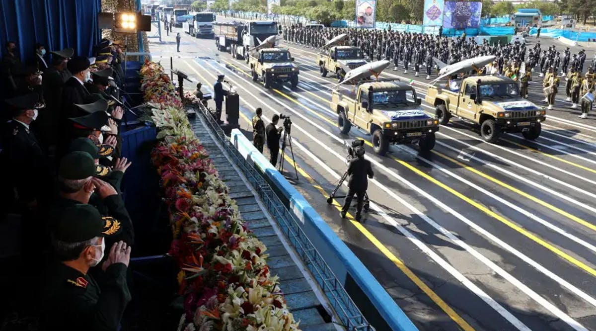 Iranian President Ebrahim Raisi and military commanders watch as military equipment passes by during a ceremony of the National Army Day