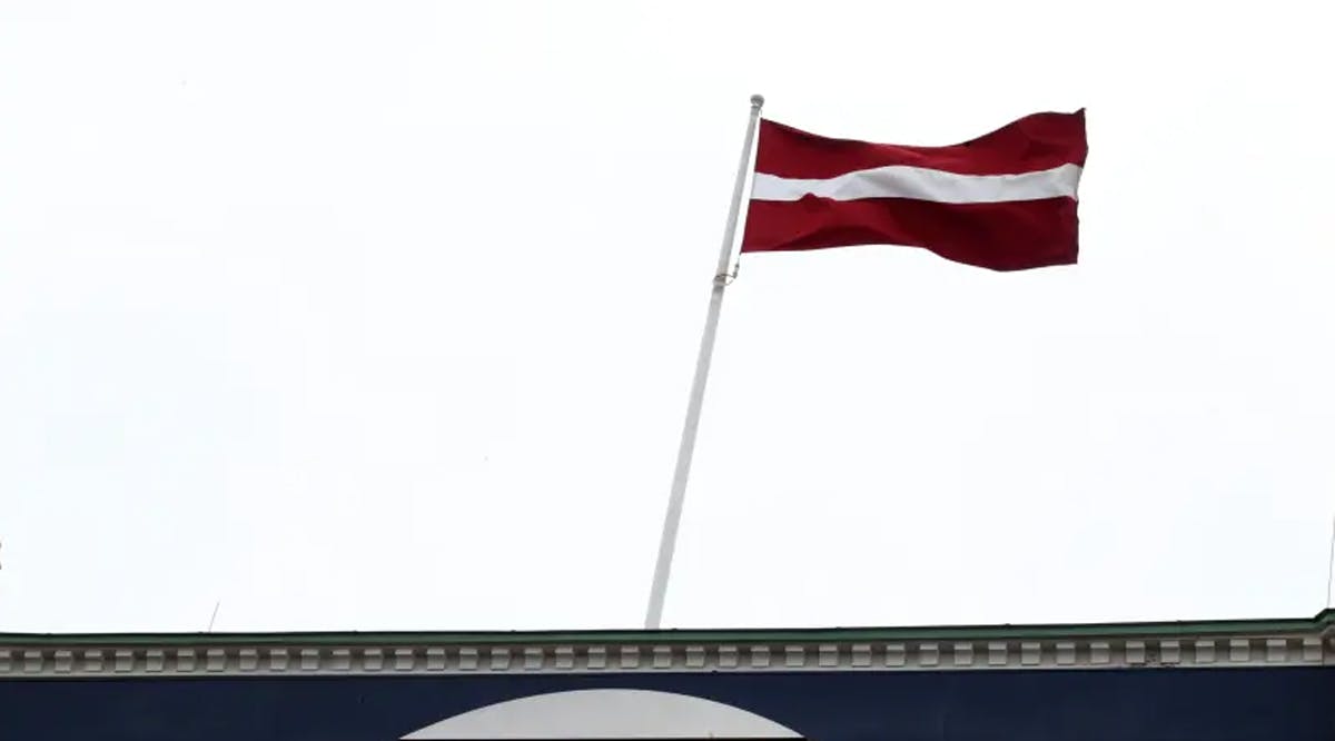 National flag flutters over Latvian central bank headquarters in Riga, Latvia